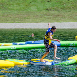 Boy climbs inflatable raft, Les Gets