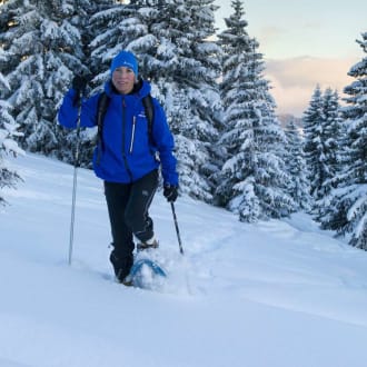 Child making snowballs in Les Gets