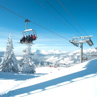 Skiers on a chair lift in Les Gets