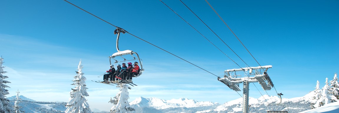 People moving on a chairlift in Les Gets