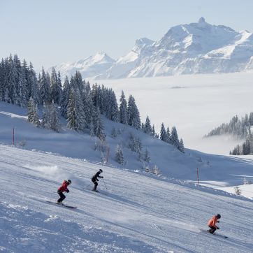 Three skiers on the slopes in Les Gets