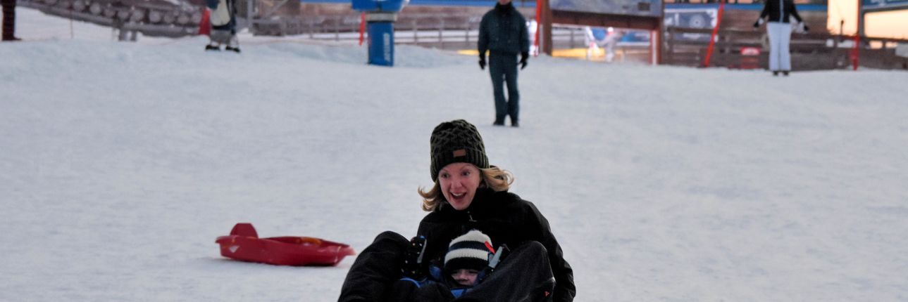 Sledging Les Gets - A lady and child sledging in Les Gets