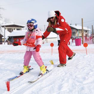 A child enjoying her ski lesson