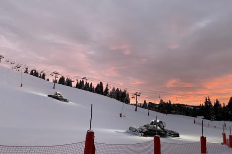 Piste bashers at work by night in Les Gets