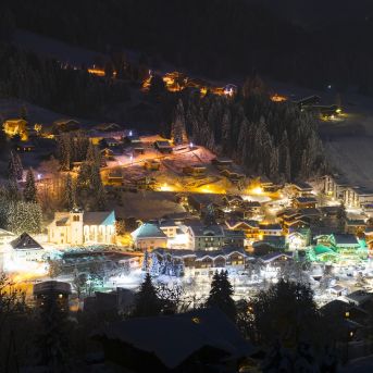 Child making snowballs in Les Gets