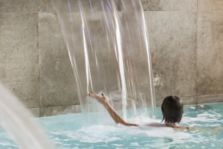 A lady in the main pool in Sources Du Chery